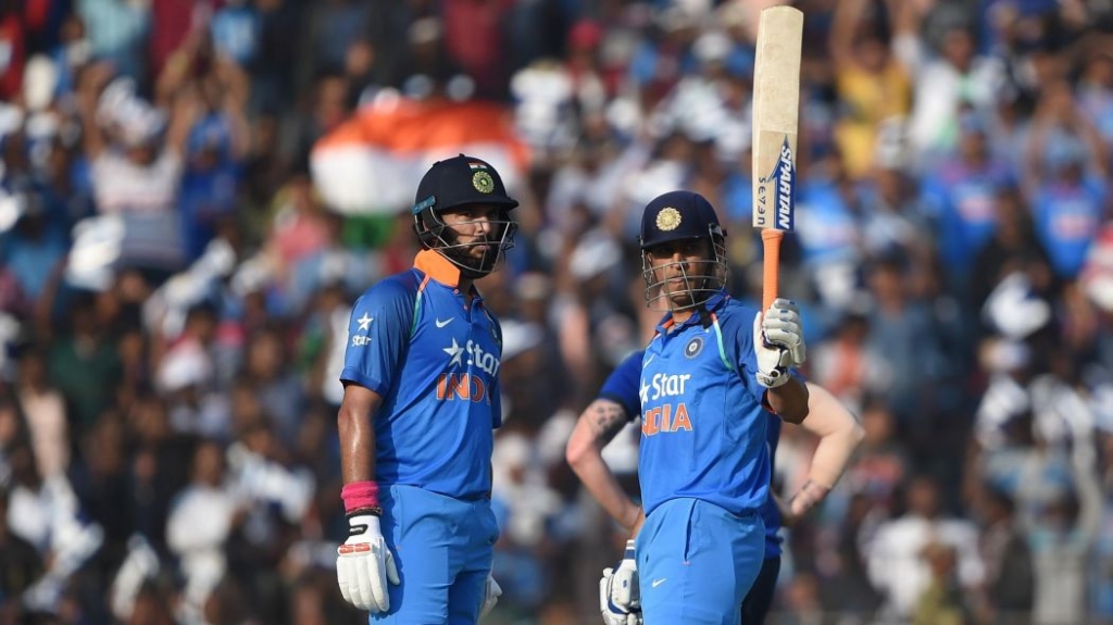 MSD raises his bat after scoring his century.