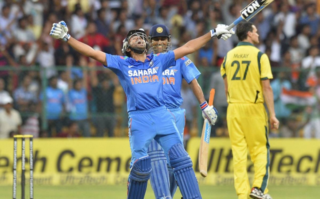 Dhoni smiles as Rohit celebrates his double century.